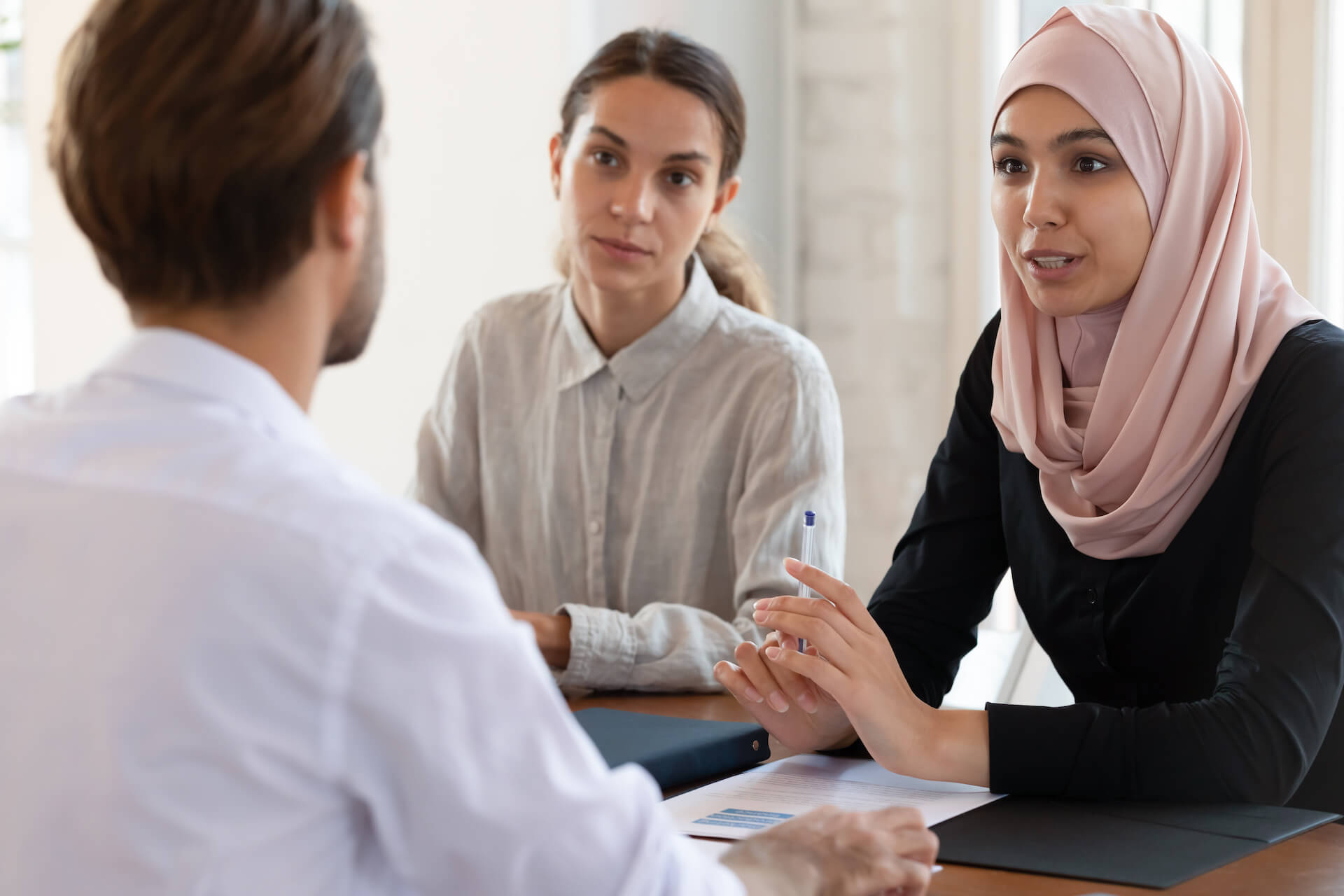 stock photo of three people in discussion