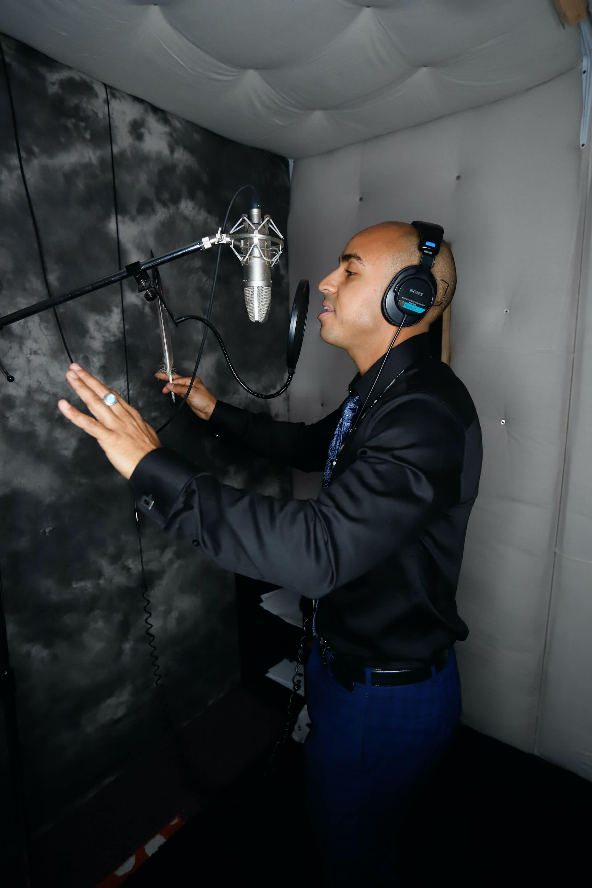 Photo of Justin recording a song in his recording-studio